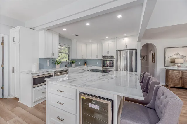 a view of kitchen with center island and stainless steel appliances