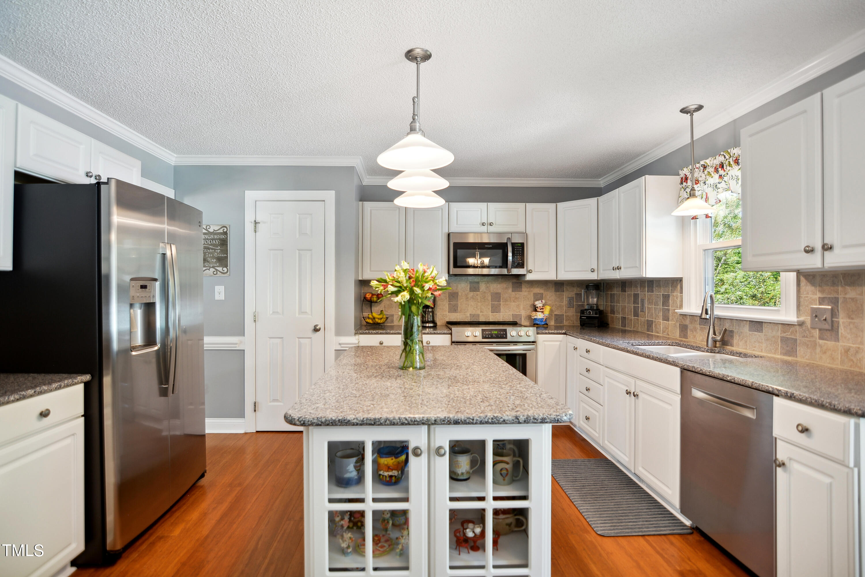 300 Foley Drive Garner, NC 27529 - Photo 11 of 29 a kitchen with kitchen island granite countertop stainless steel appliances a sink stove and refrigerator