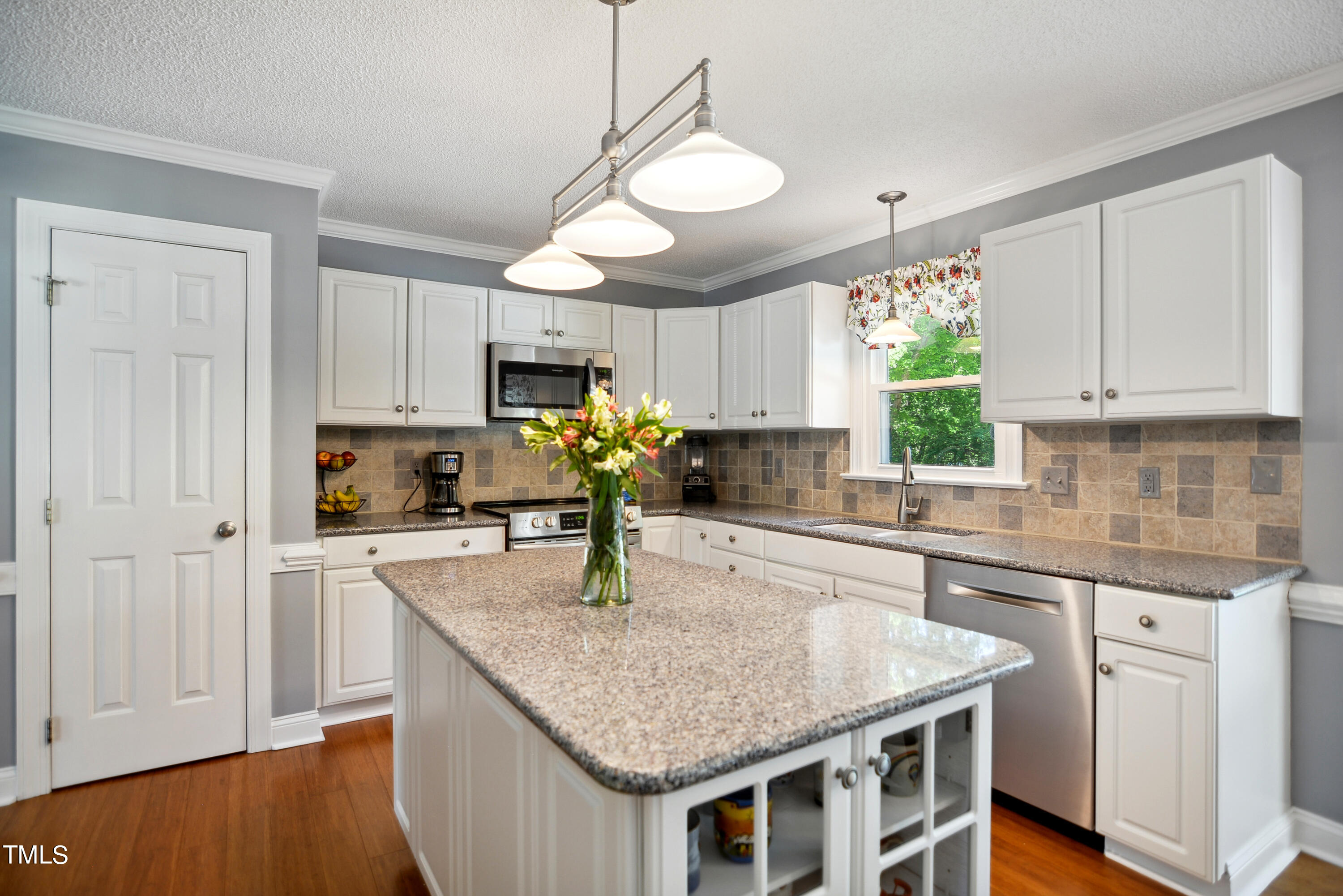 300 Foley Drive Garner, NC 27529 - Photo 12 of 29 a kitchen with kitchen island granite countertop a sink a center island and cabinets