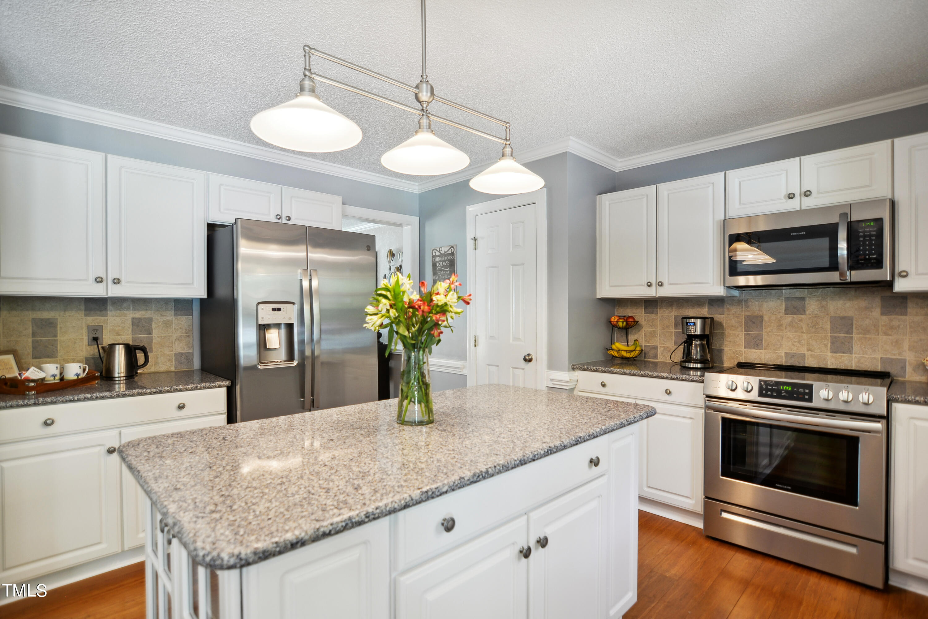 300 Foley Drive Garner, NC 27529 - Photo 13 of 29 a kitchen with granite countertop a sink cabinets and stainless steel appliances