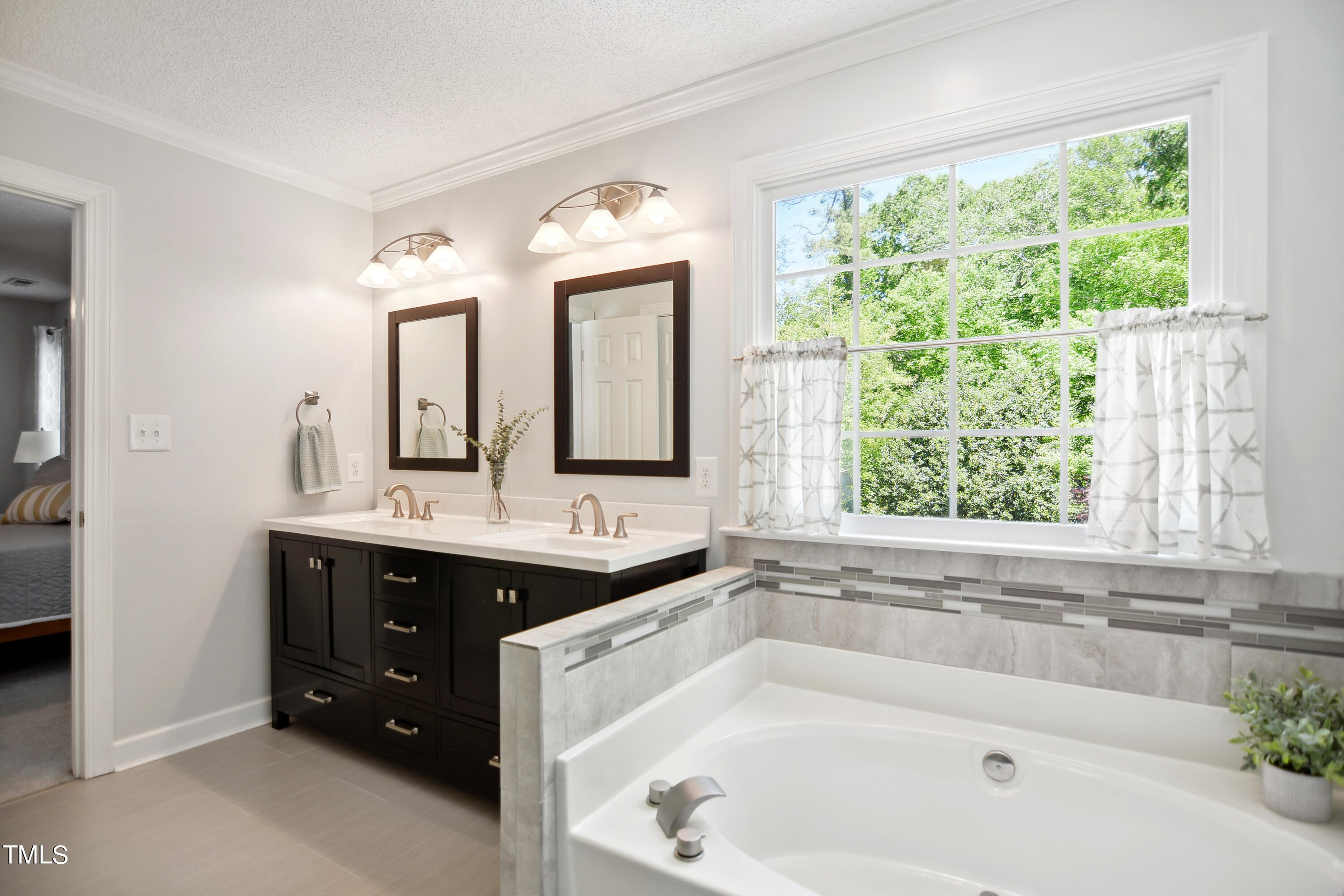300 Foley Drive Garner, NC 27529 - Photo 17 of 29 a bathroom with a tub sink and mirror
