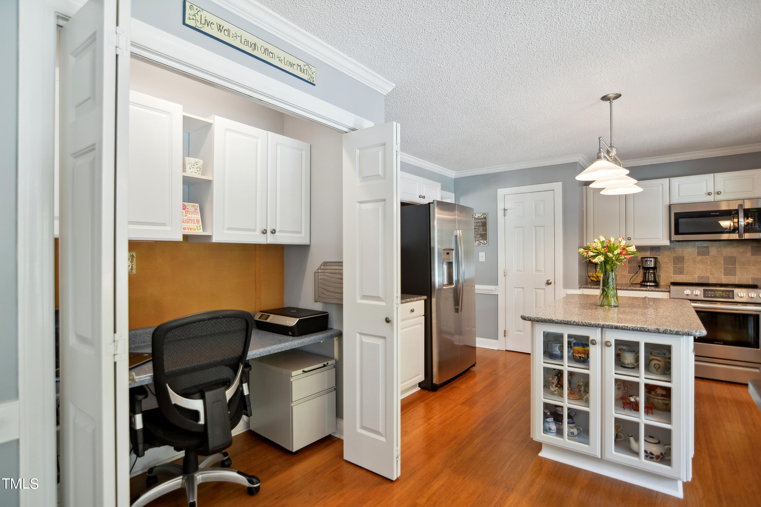 300 Foley Drive Garner, NC 27529 - Photo 10 of 29 a kitchen with a refrigerator a stove and white cabinets with wooden floor