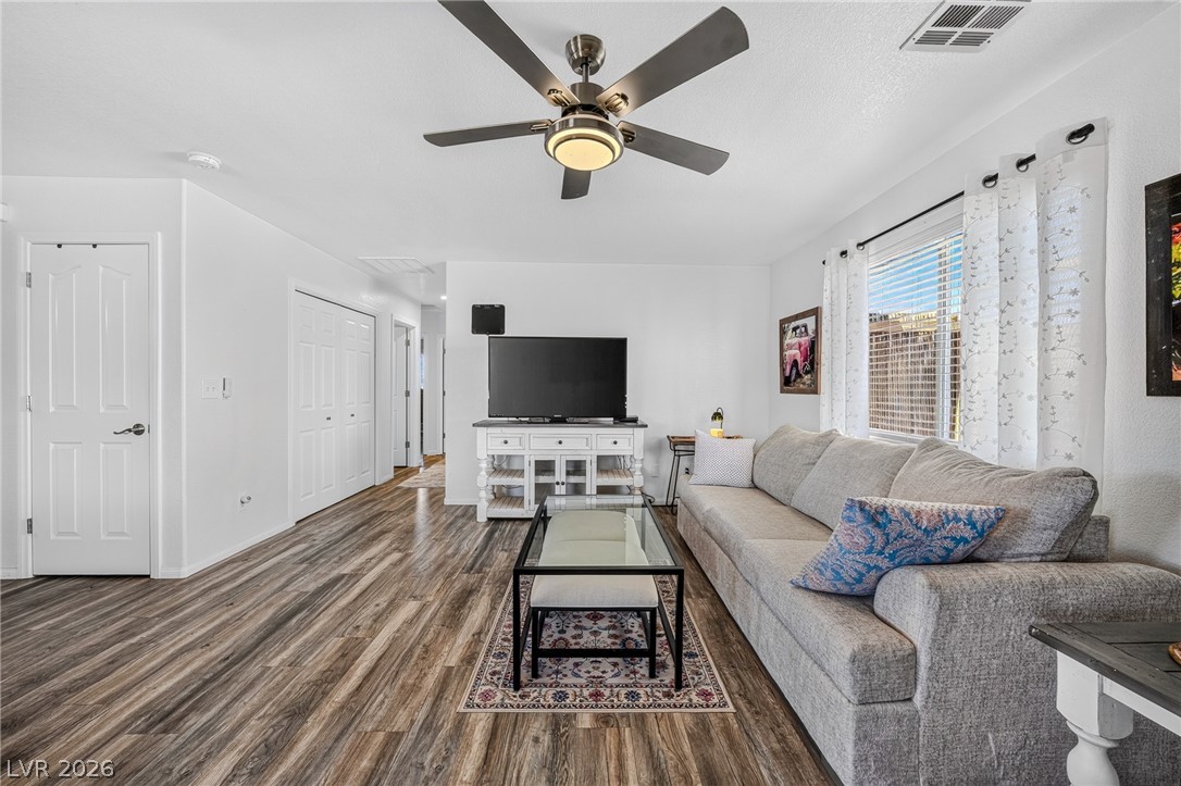 2970 Rio Rico Drive Pahrump, NV 89048 - Photo 11 of 41 Rich wood-look flooring and tall windows define this open living space.
