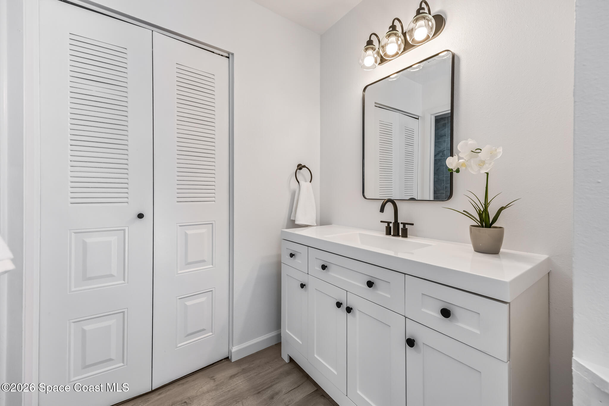 1411 Sheafe Avenue Northeast, Unit 101 Palm Bay, FL 32905 - Photo 13 of 24 a bathroom with double vanity sink and a mirror