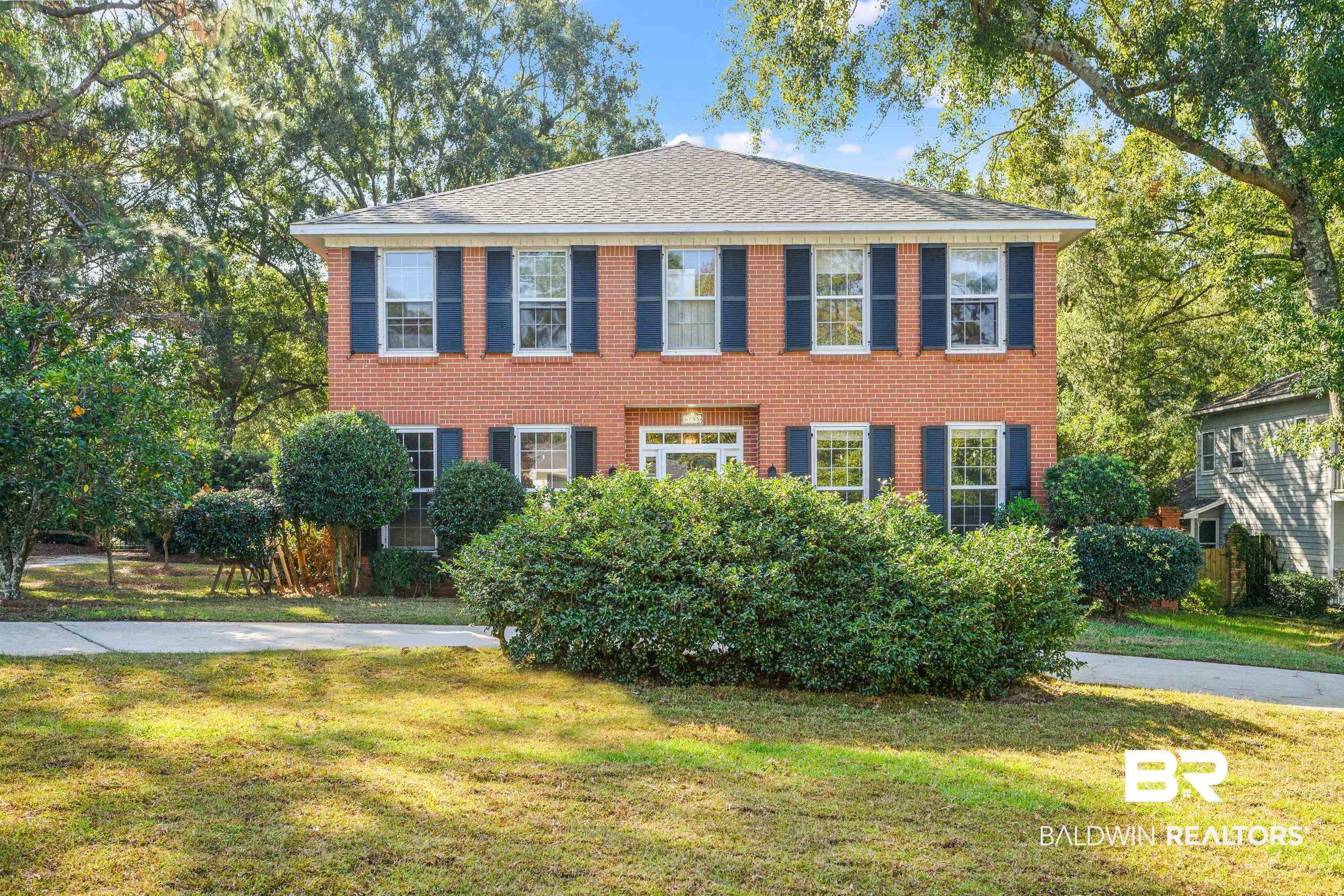 Colonial house featuring a front lawn