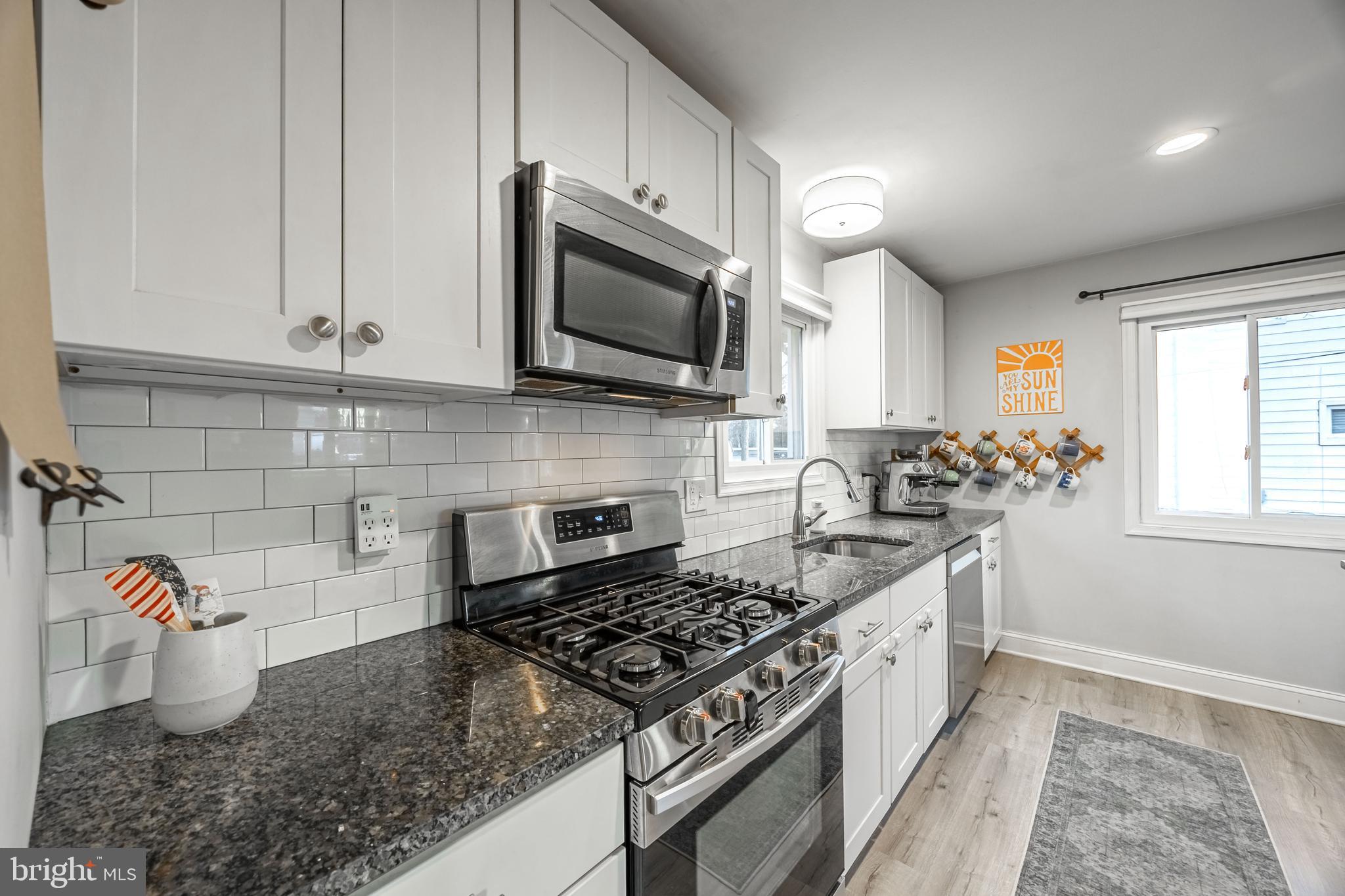1001 Nancy Road Glen Burnie, MD 21061 - Photo 11 of 30 a kitchen with stainless steel appliances granite countertop a sink stove and microwave