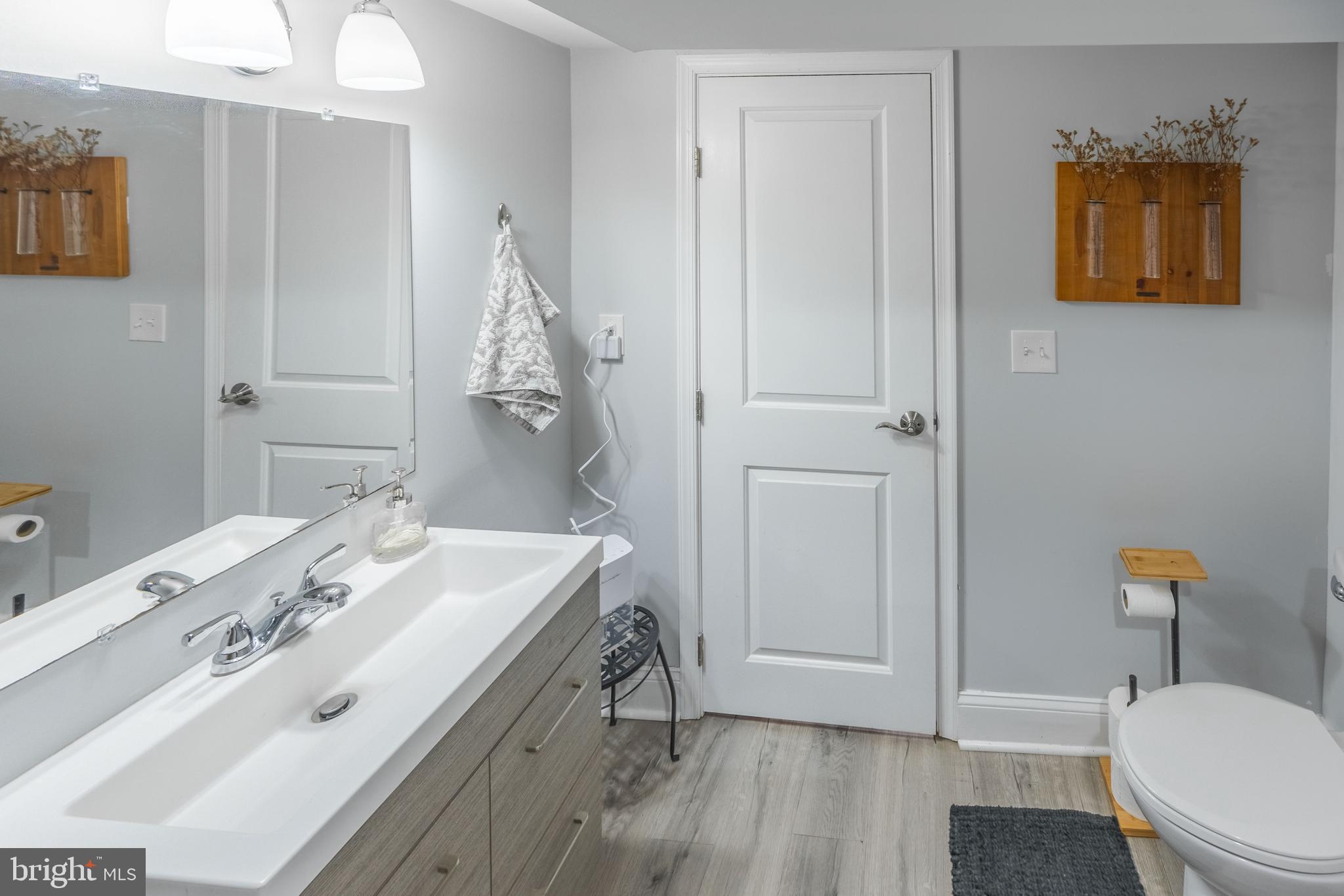 1001 Nancy Road Glen Burnie, MD 21061 - Photo 24 of 30 a bathroom with a sink a toilet and shower