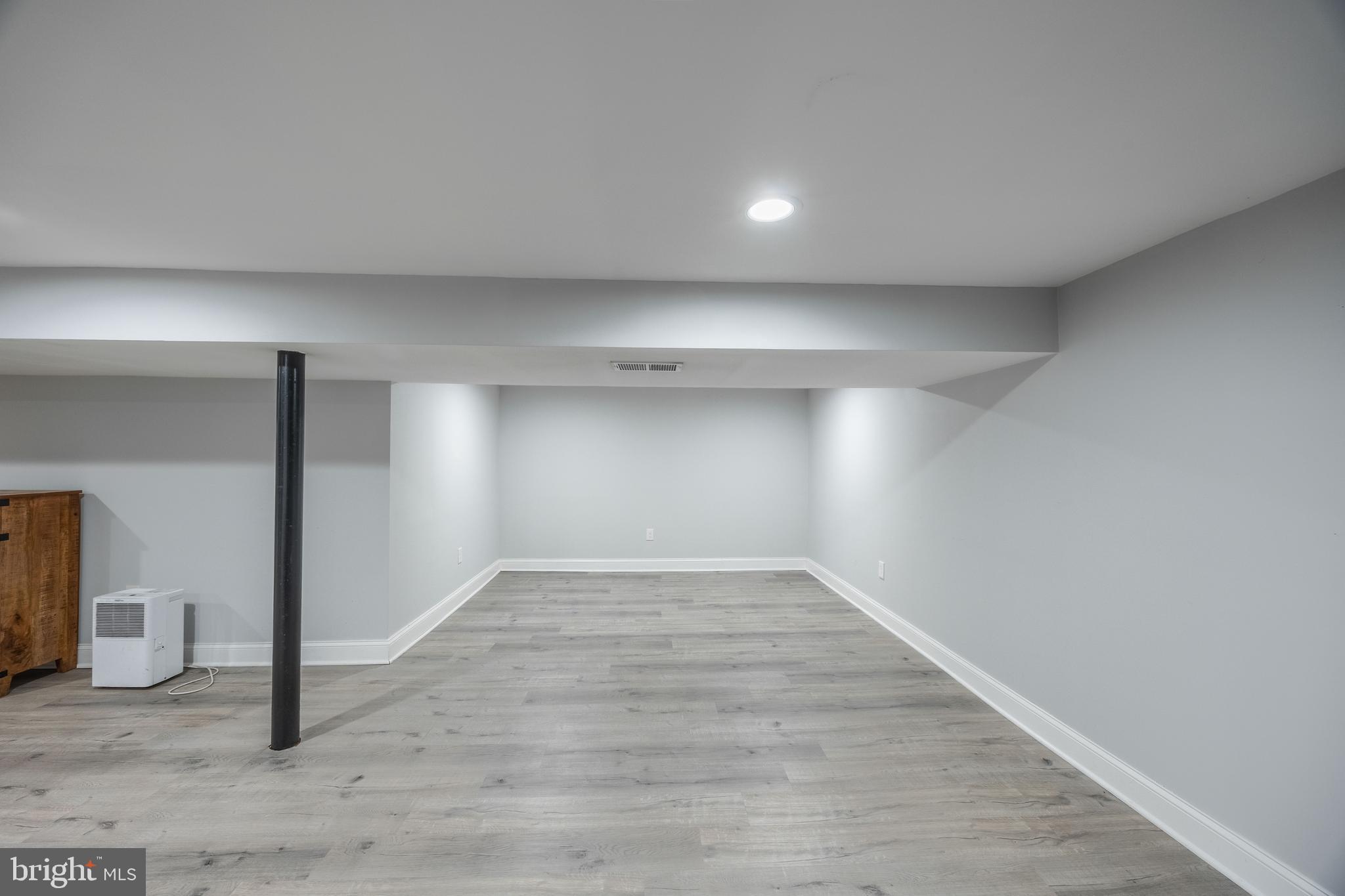 1001 Nancy Road Glen Burnie, MD 21061 - Photo 30 of 30 an empty room with wooden floor and windows