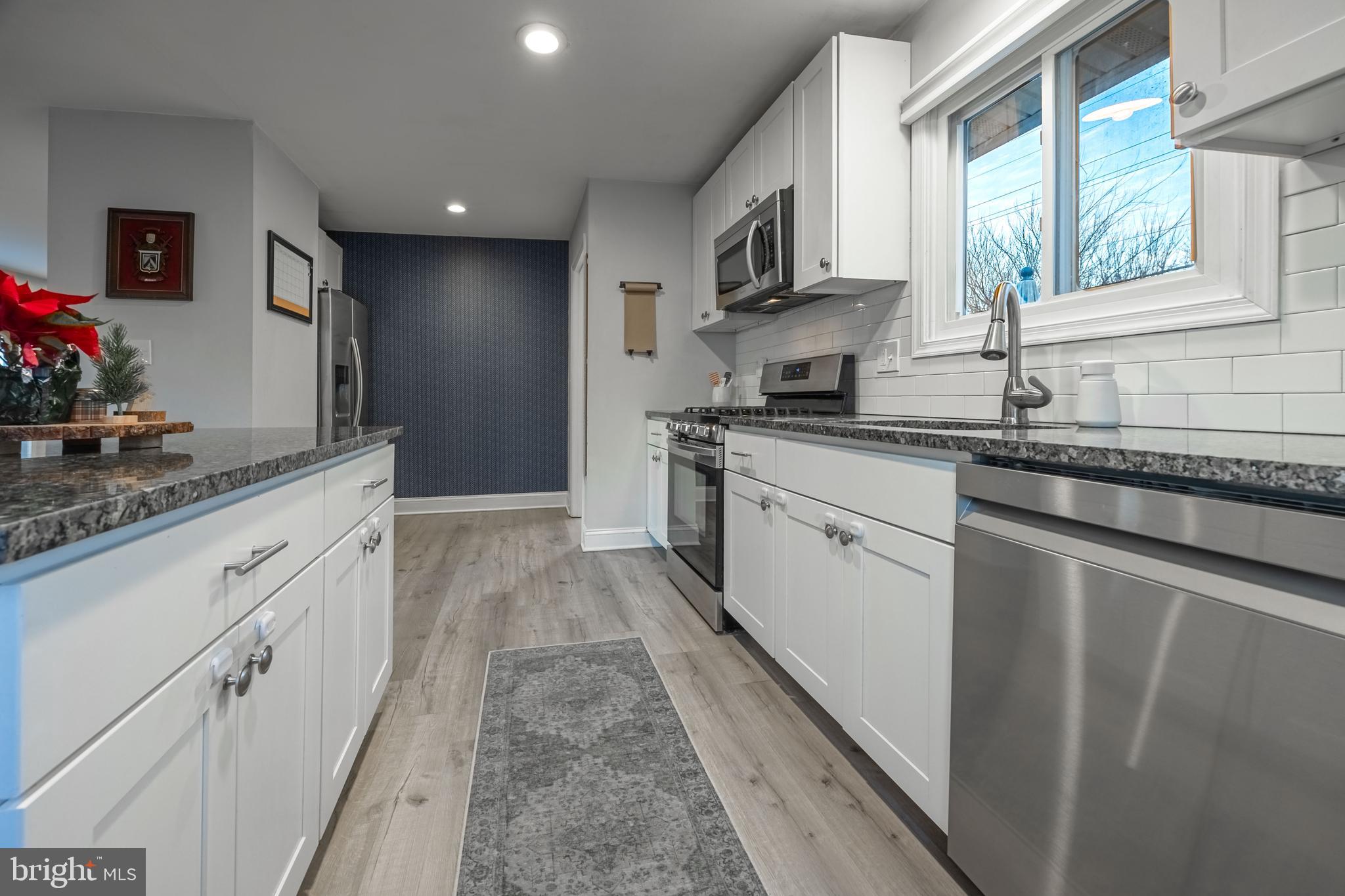 1001 Nancy Road Glen Burnie, MD 21061 - Photo 8 of 30 a kitchen with a sink stove and cabinets