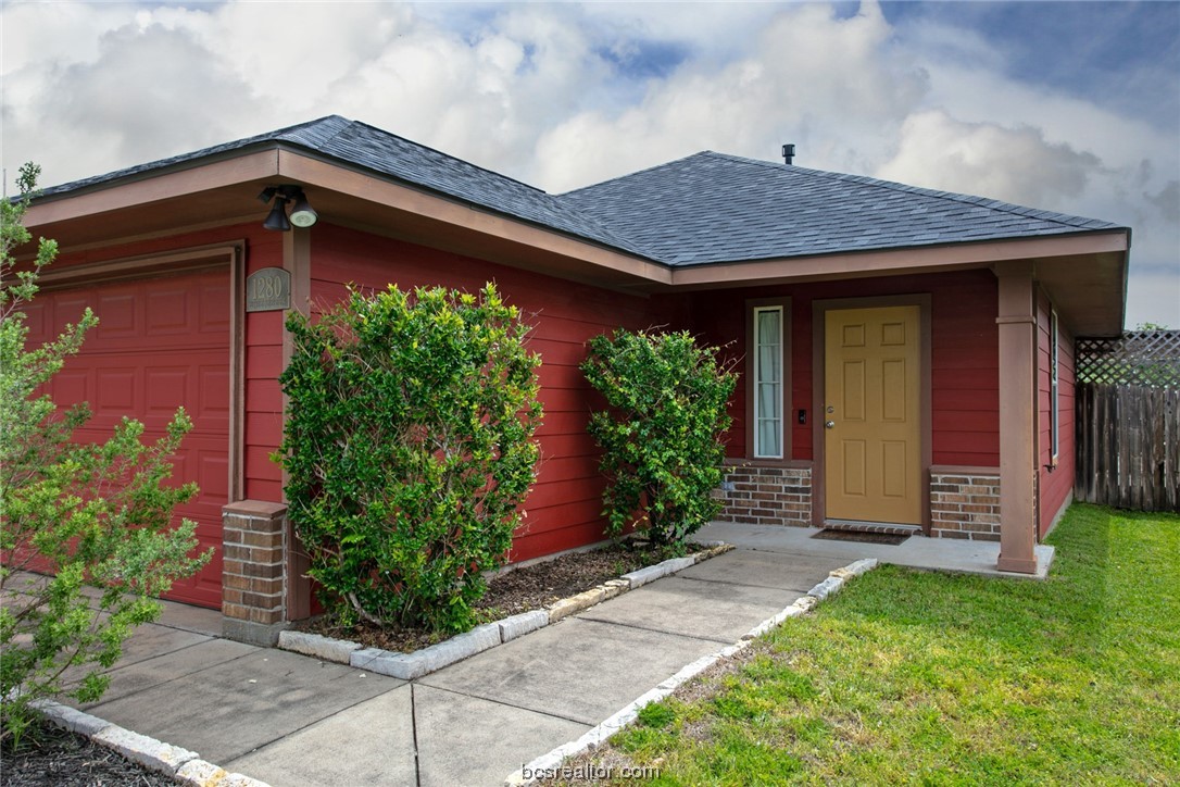 1280 Cottage Grove Circle Bryan, TX 77801 - Photo 1 of 1 a front view of a house with garden