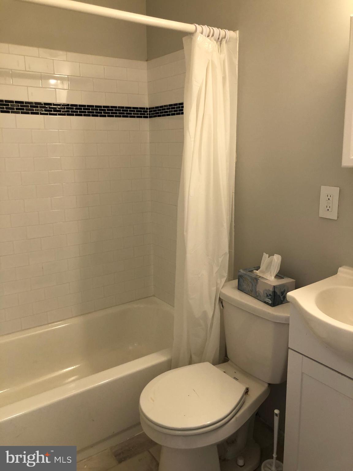 8726 Marsden Street Philadelphia, PA 19136 - Photo 11 of 24 a white toilet sitting next to a bath tub