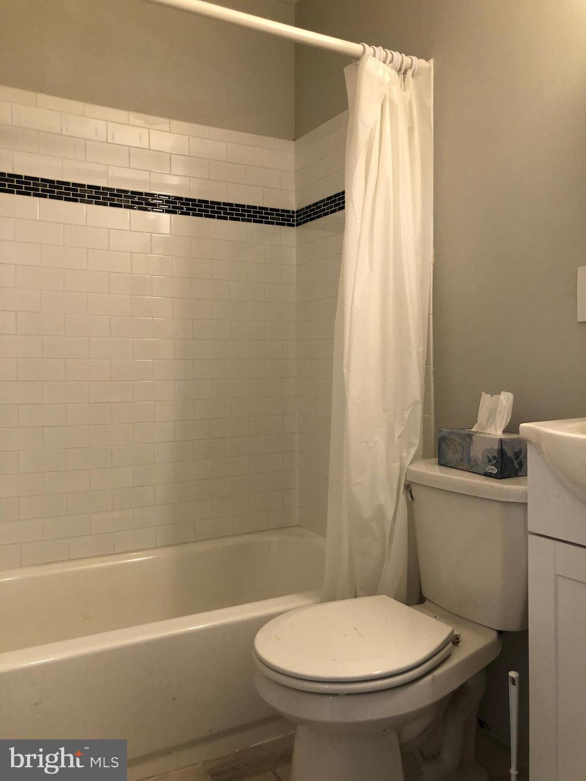 8726 Marsden Street Philadelphia, PA 19136 - Photo 14 of 24 a white toilet sitting next to a bath tub and shower