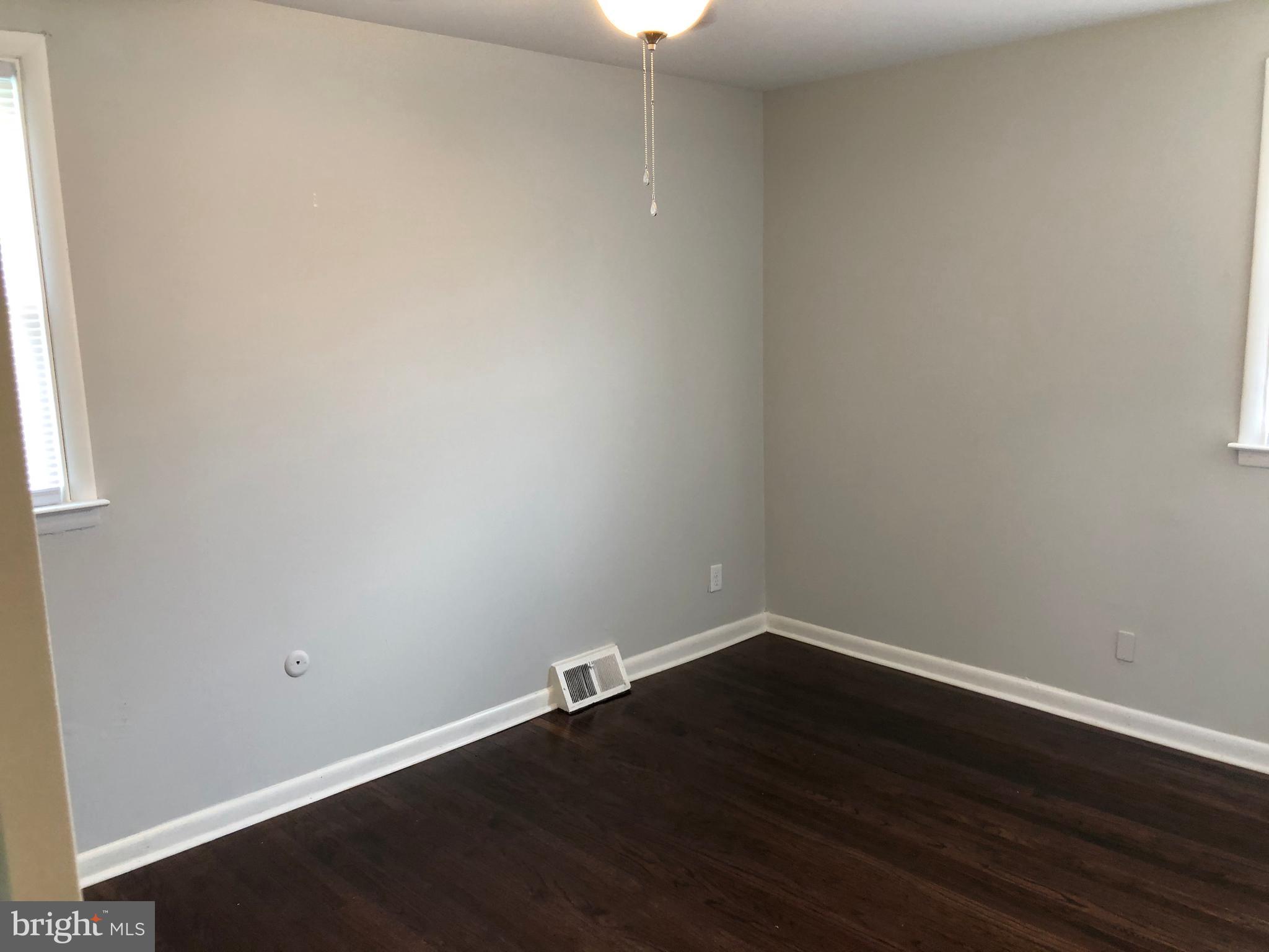 8726 Marsden Street Philadelphia, PA 19136 - Photo 16 of 24 an empty room with wooden floor and windows