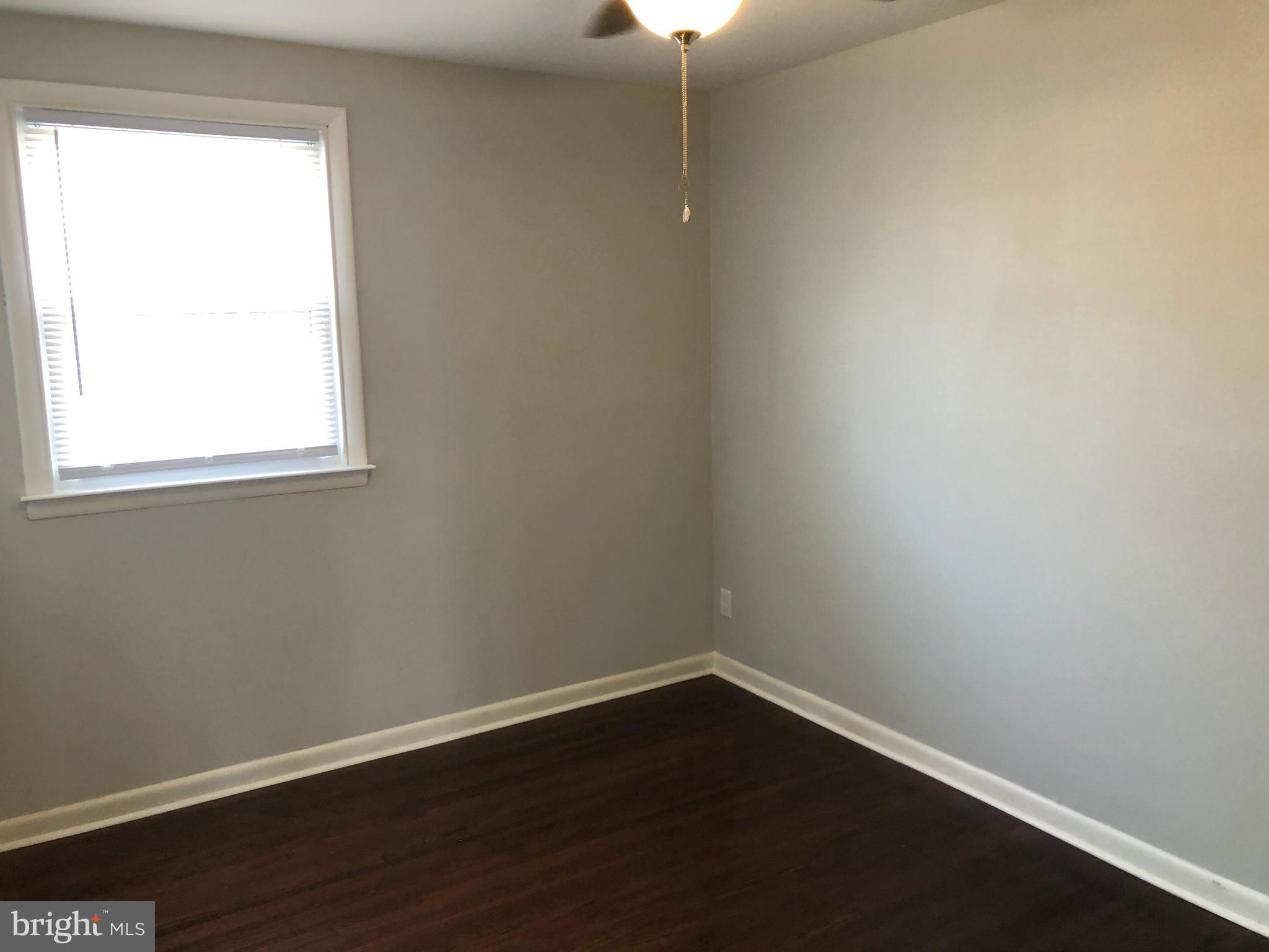 8726 Marsden Street Philadelphia, PA 19136 - Photo 18 of 24 an empty room with wooden floor and windows