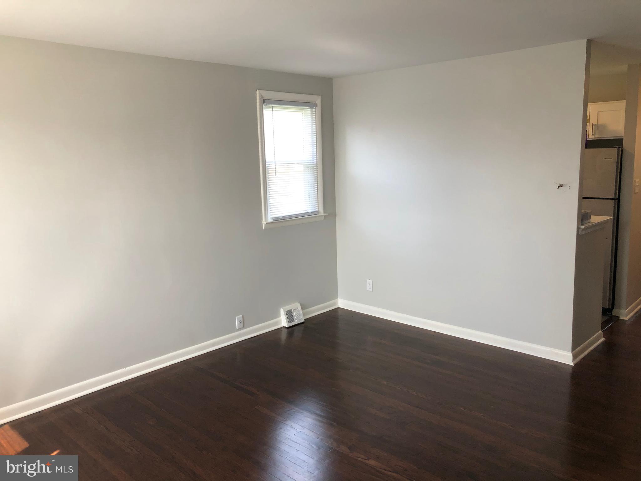 8726 Marsden Street Philadelphia, PA 19136 - Photo 5 of 24 an empty room with wooden floor and windows