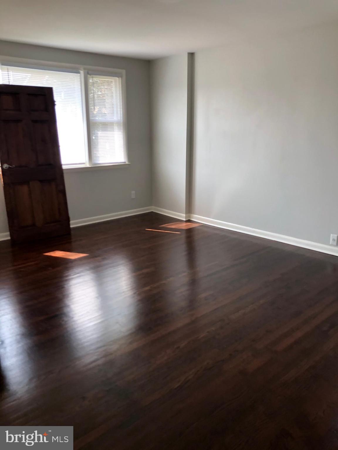 8726 Marsden Street Philadelphia, PA 19136 - Photo 7 of 24 an empty room with wooden floor and windows