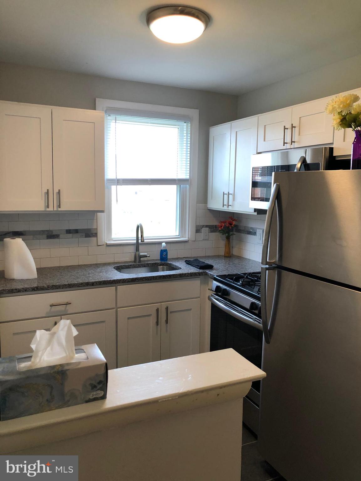 8726 Marsden Street Philadelphia, PA 19136 - Photo 9 of 24 a kitchen with a refrigerator and a sink