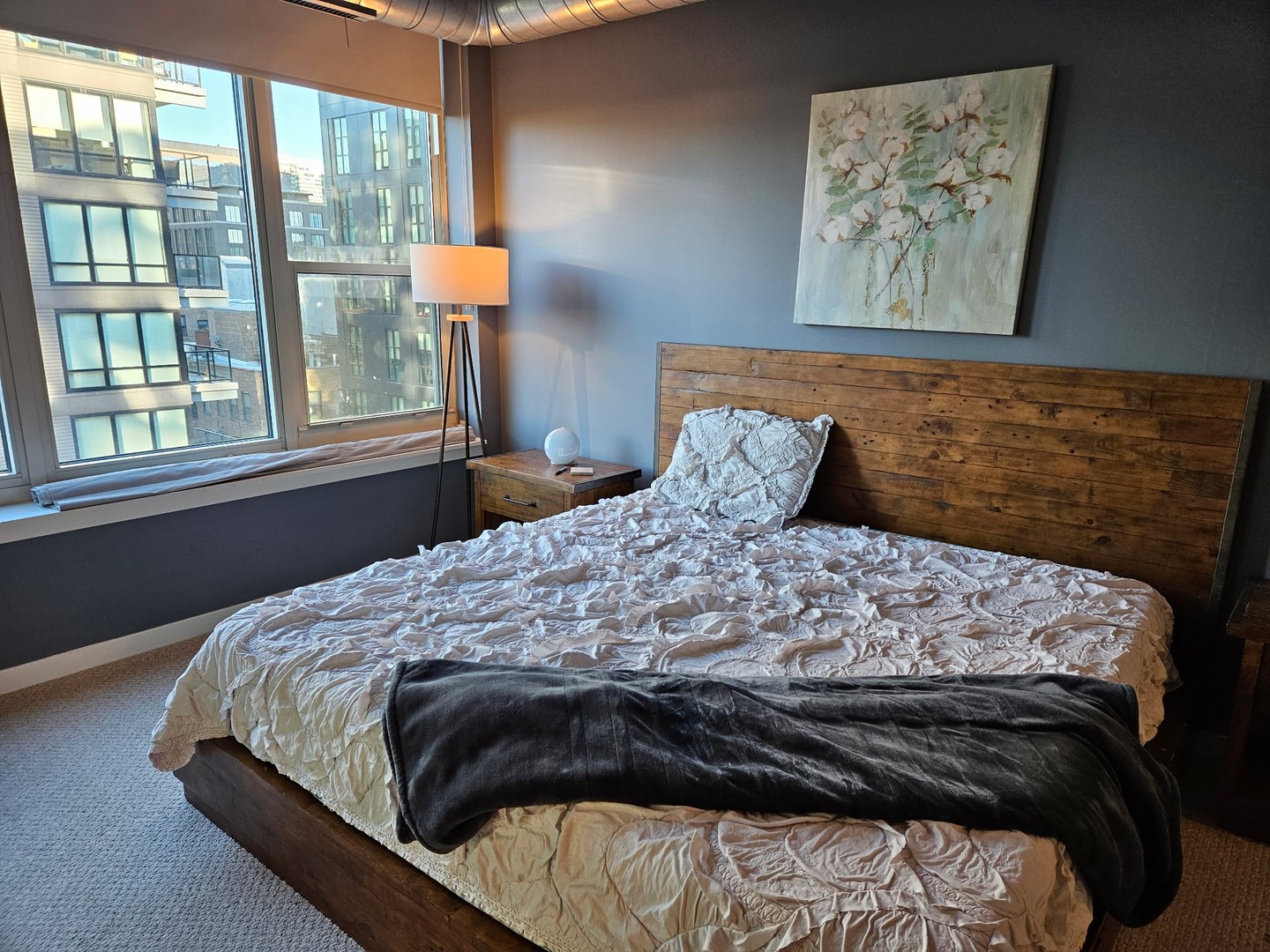 909 West Washington Boulevard, Unit 708 Chicago, IL 60607 - Photo 11 of 15 a bed sitting in a bedroom next to a window