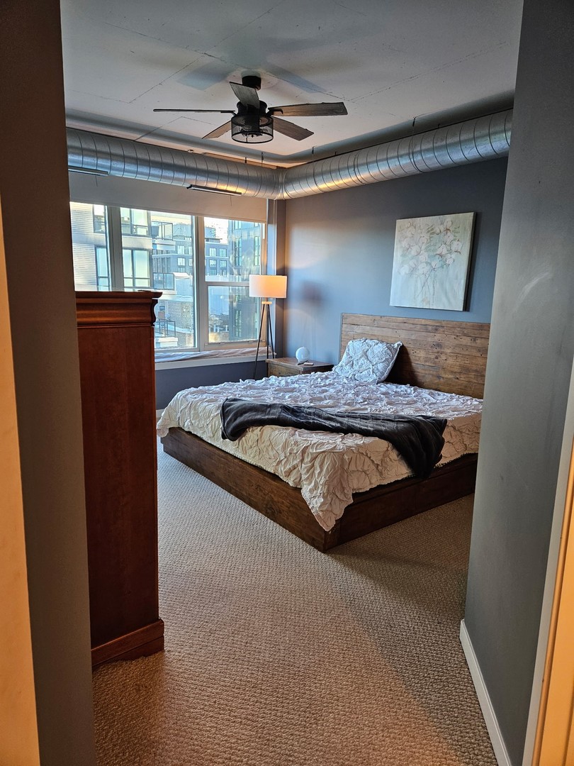 909 West Washington Boulevard, Unit 708 Chicago, IL 60607 - Photo 12 of 15 a bed sitting in a room next to a window