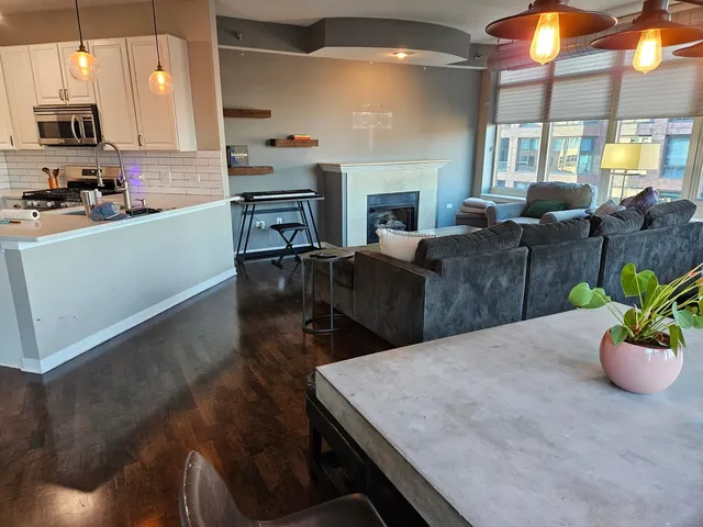 a kitchen with a table chairs sink and cabinets