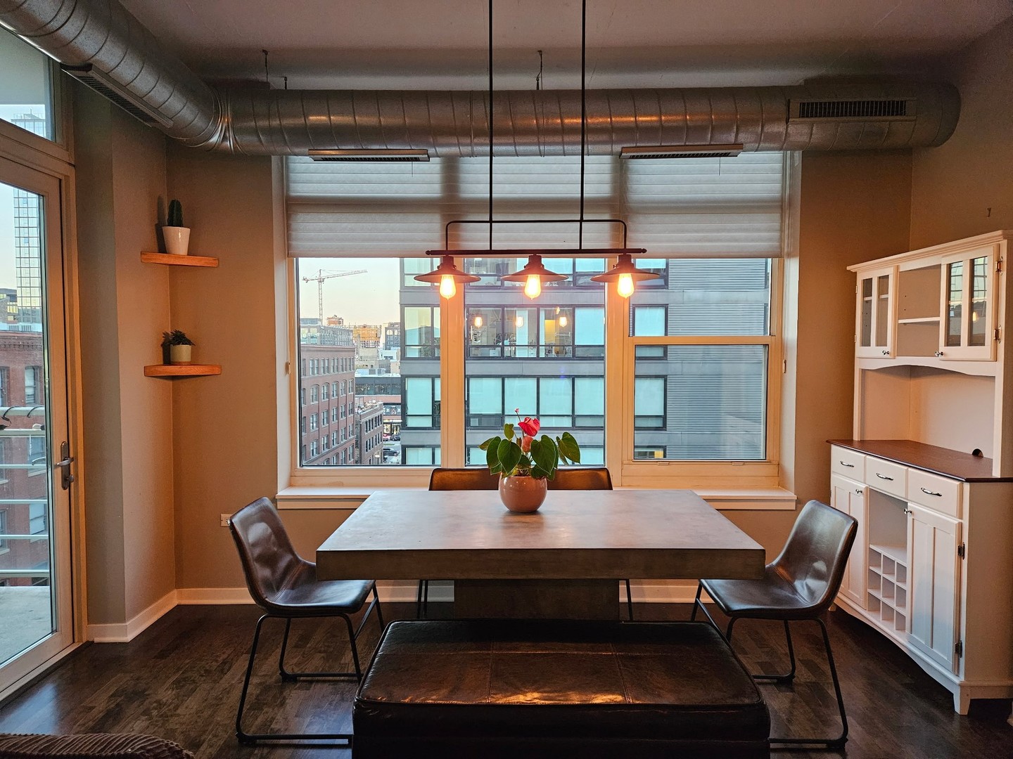 909 West Washington Boulevard, Unit 708 Chicago, IL 60607 - Photo 8 of 15 a view of a dining room with furniture window and wooden floor