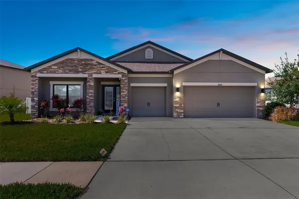 a front view of a house with a yard and garage