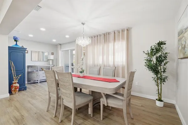 a dining room with furniture and wooden floor