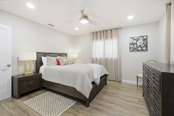 a bedroom with a bed and a chair