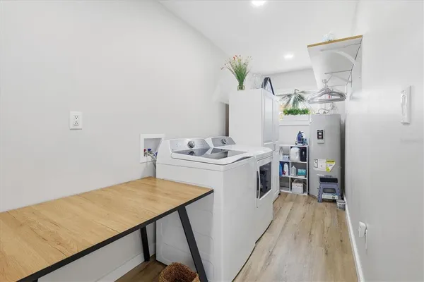 a front view of house with yard and trees in the background