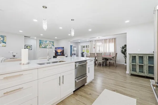 a kitchen with stainless steel appliances a refrigerator sink and microwave