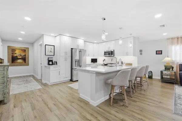 a living room with lots of furniture and a wooden floor