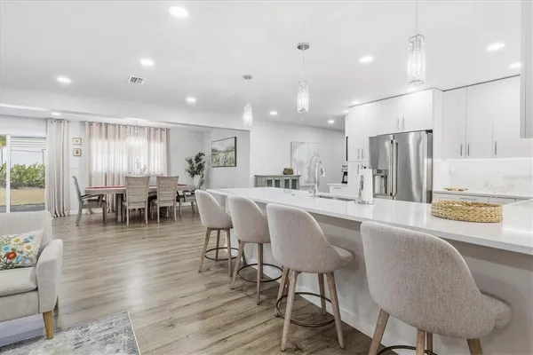 a dining room with furniture and wooden floor