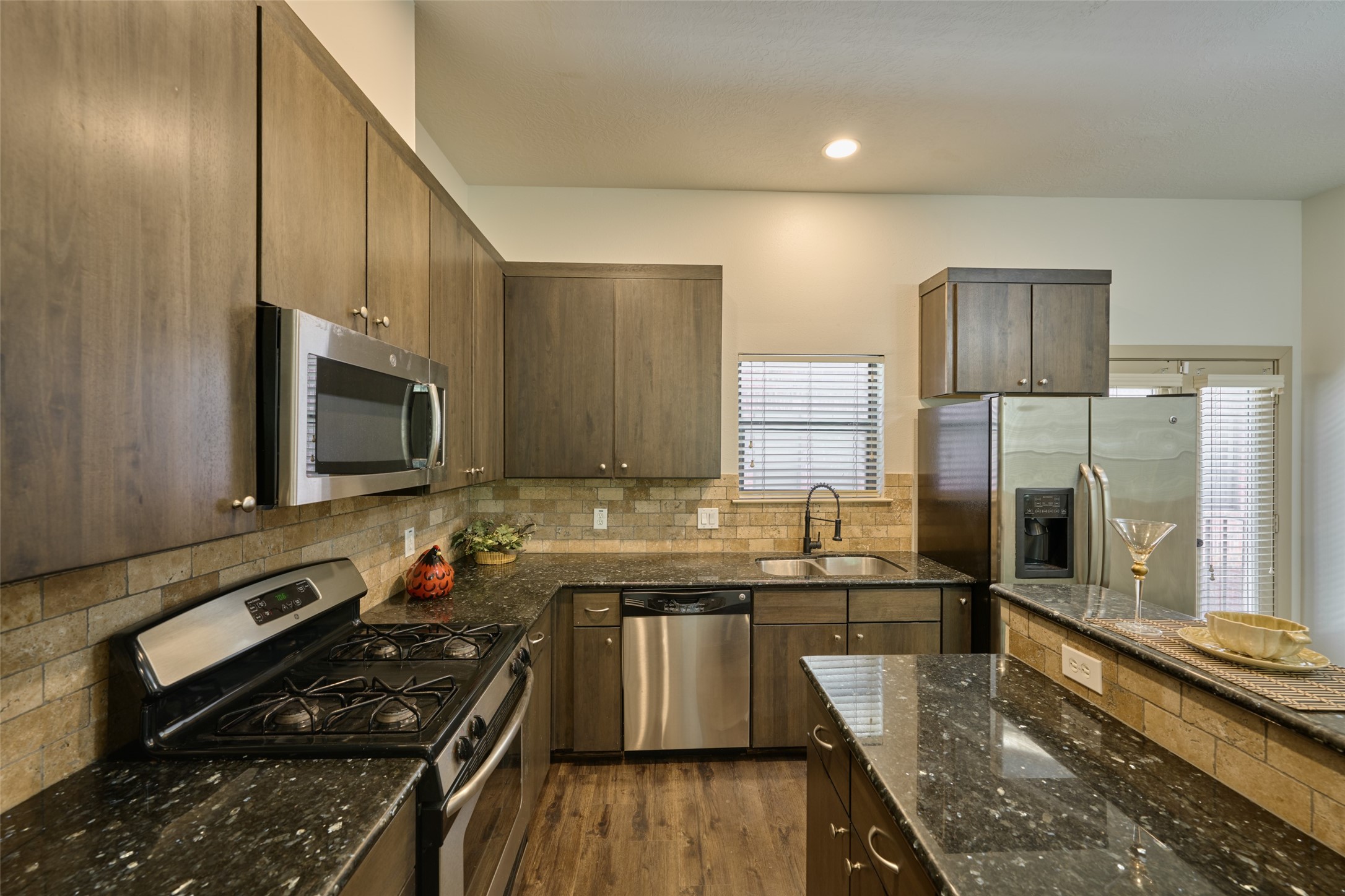2422 Navigation Boulevard, Unit E Houston, TX 77003 - Photo 17 of 29 a kitchen with stainless steel appliances granite countertop a stove a sink and a microwave