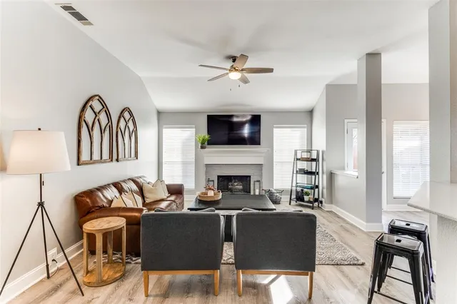 a living room with furniture a fireplace and a flat screen tv