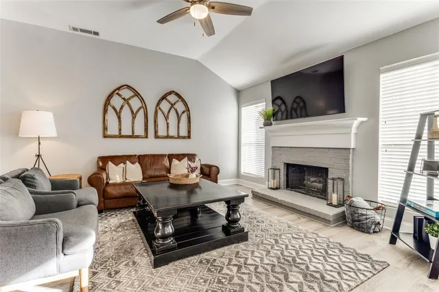 a living room with furniture and a fireplace