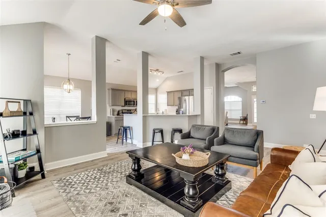 a living room with furniture and wooden floor