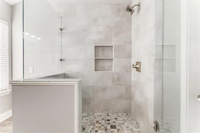 a bathroom with a shower and a sink
