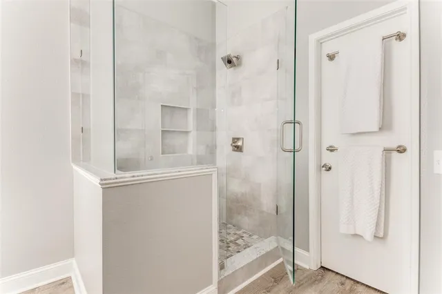 a bathroom with a glass shower door