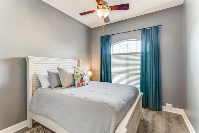 a bedroom with a large bed and a chandelier