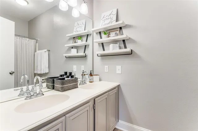 a bathroom with a sink a mirror and vanity