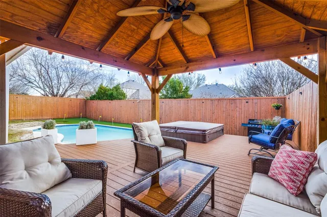 a view of a patio with couches chairs and a small umbrella