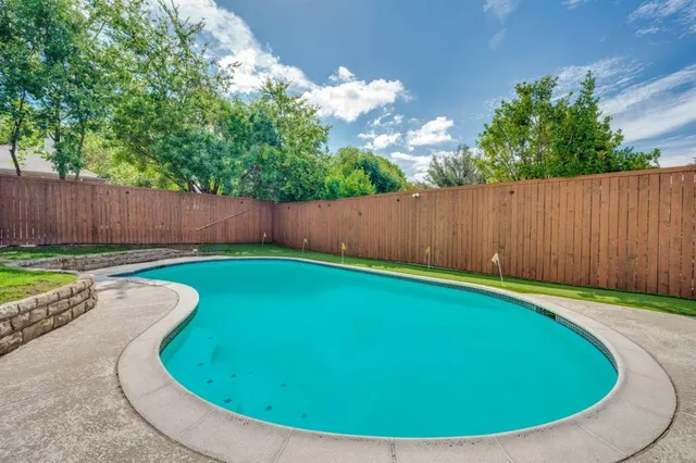 a view of swimming pool in a backyard