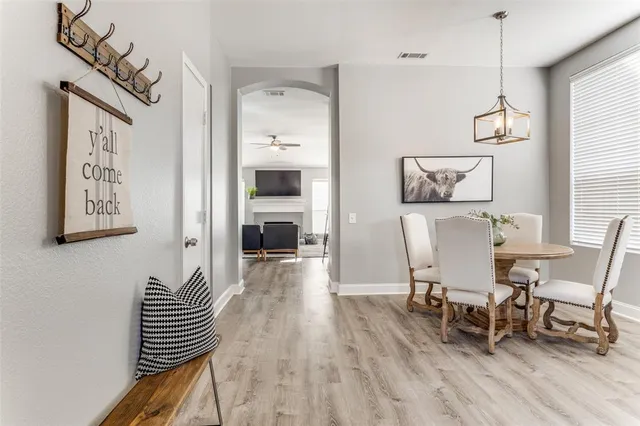 a view of a dining room with furniture and wooden floor