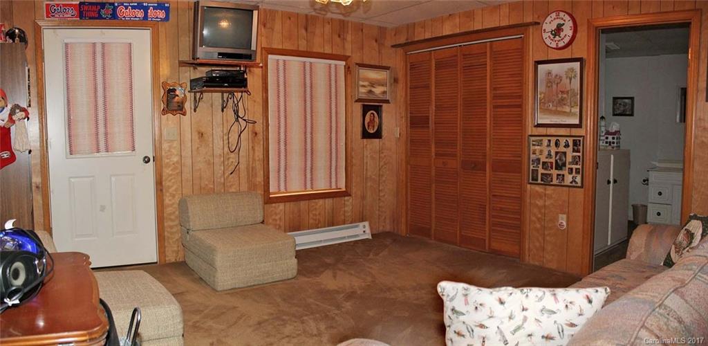 554 Quail Cove Road Clyde, NC 28721 - Photo 22 of 24 a living room with a couch and a dresser