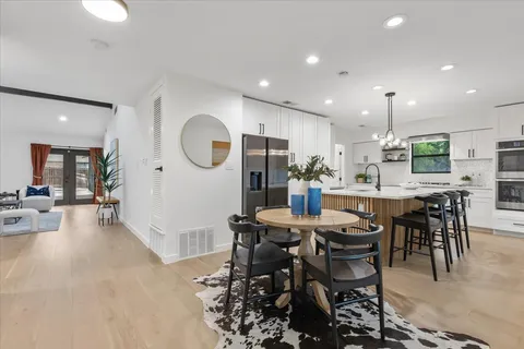 a large kitchen with a table and chairs