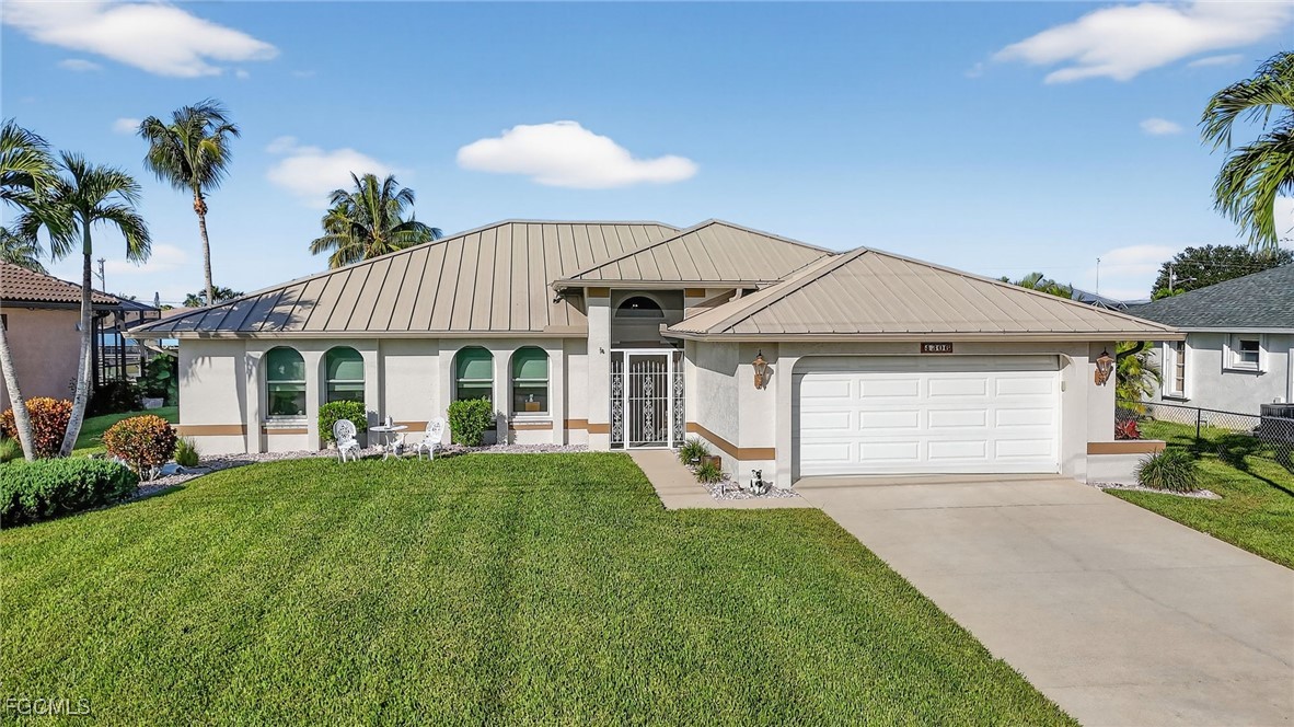 4306 Southwest 3rd Avenue Cape Coral, FL 33914 - Photo 1 of 50 a front view of a house with a garden and porch