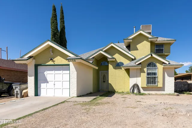 a view of a house with a yard and garage