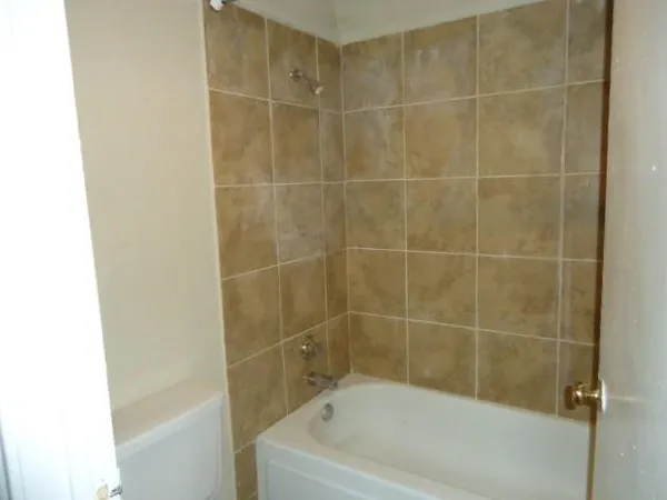 a bath tub sitting next to a white sink