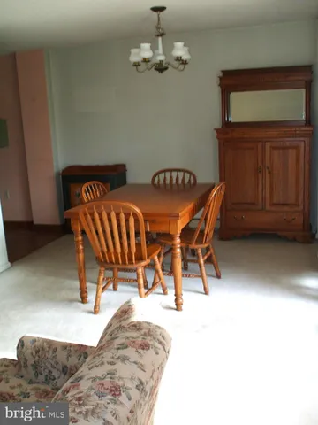 a view of a dining room with furniture and chandelier