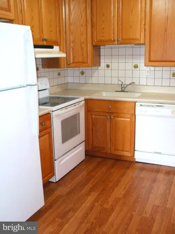 a kitchen with stainless steel appliances granite countertop a sink a stove a microwave and cabinets